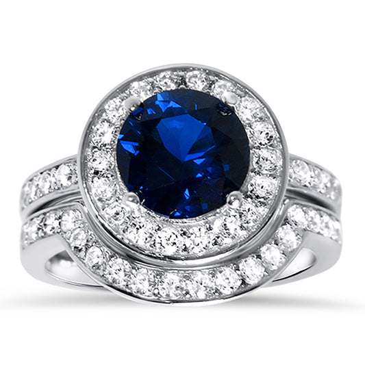 Front view of the women's blue sapphire bridal ring set, showing the engagement ring and matching wedding band on white.