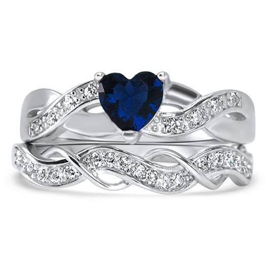 Front view of the women's blue sapphire bridal ring set, showing the engagement ring and matching wedding band on white.